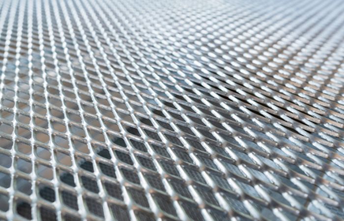 A full sheet of expanded metal with a uniform diamond mesh, commonly used in industrial flooring, fencing, and filtration.