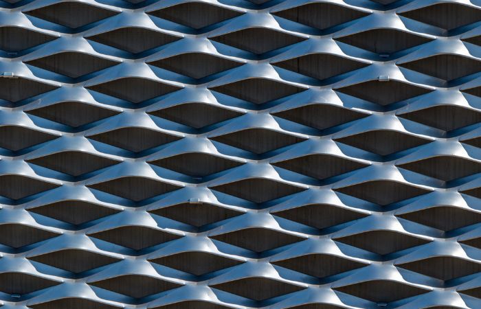 A close-up of expanded metal with a blue tint, offering a visual variation for specialized applications or design accents.