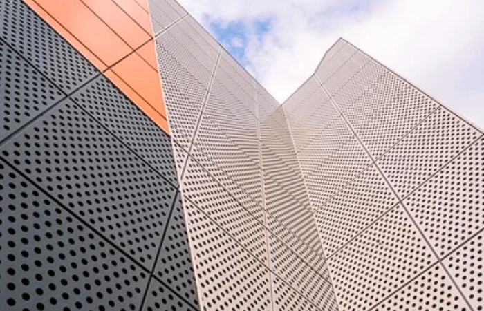 A building facade constructed with perforated metal panels, demonstrating modern design and functional ventilation.